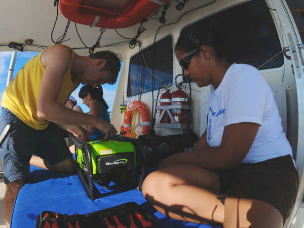 Todd Hallenbeck and Alexis Hall work together to troubleshoot and fix a minor problem with the ROVs thrusters.  