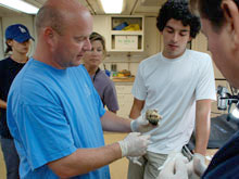 Dr. Tim Shank discusses a seafloor specimen with other members of the science party.