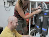 Jay Lunden gets help from Lara Miles in collecting water samples.