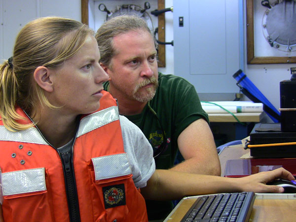 Halligan & Loebel run computers while the crew deploys the towfish.
