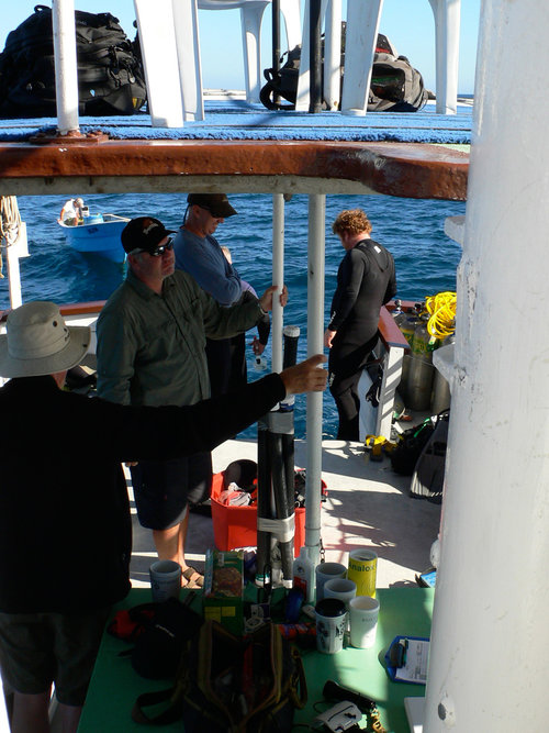 View of the lower and upper deck of the Pez Sapo dive boat. The lower deck is the dive deck, while the upper deck is used as an office with laptops set up.