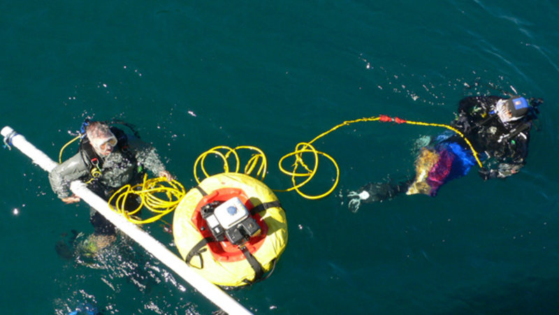 Loren Davis and Kaya Chotard prepare to use the airlift device to collect samples from the sea floor.