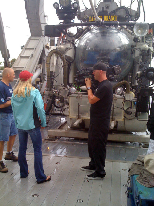 Jan Petri (left) talks with members of the CNN news team aboard R/V Seward Johnson.