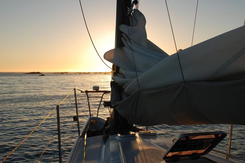 The sun sets over the bow of the <em>Derek M. Baylis</em>, anchored near Shelter Cove after a successful day of multibeam surveys.