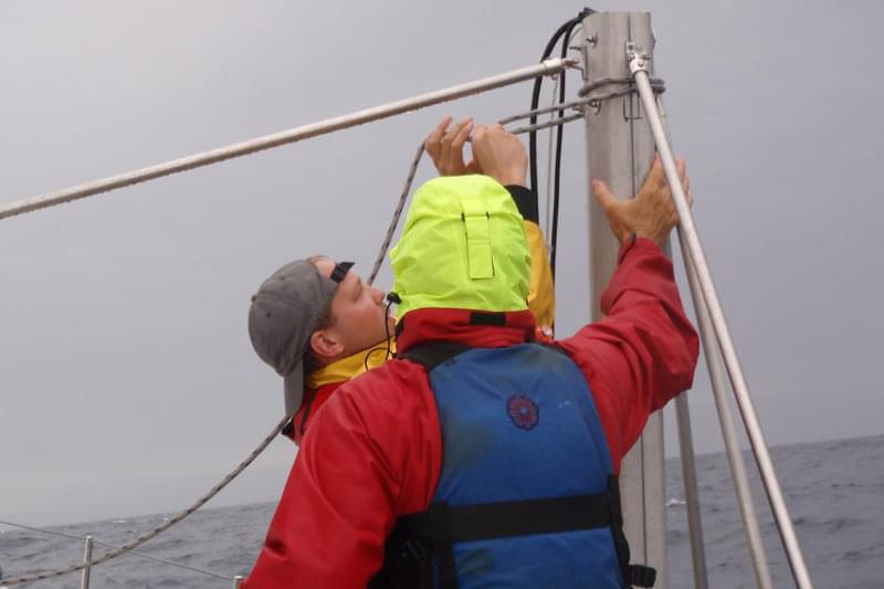 Morgan Erhardt works with the Baylis crew member Mark Kocina to secure the strut and continue multibeam operations.