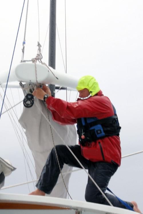 Mark Kocina of the Baylis’s crew secures the sails as weather moves in.