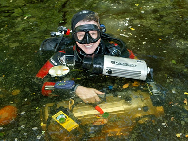 Jill Heinerth with an HD camera in Amphibico housing preparing to dive during a BBC Shoot for the program Naked Earth.