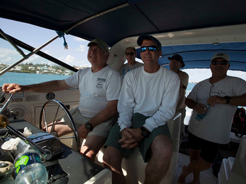 Captain Graham Maddocks bravely gives Paul Heinerth a run at driving the Triangle Divers' boat, Pourquoi Pas. Doc Pete, Marcus and Brian are in the back row.