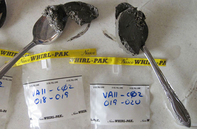 Samples of the core are removed at 1-cm intervals using spoons, and packaged and labeled for further laboratory analysis.