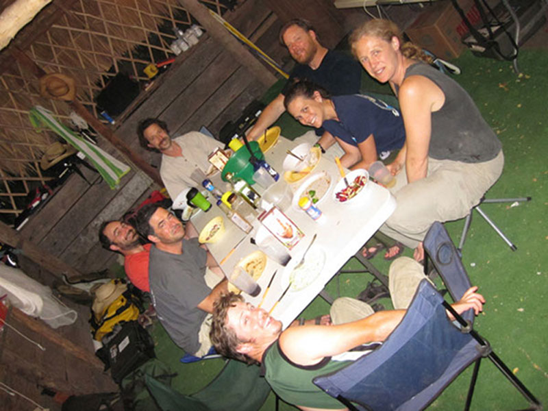 The team at Vista Alegre gathers around the table at camp for dinner. In addition to explorations and sampling during the day, the team also had to cook and clean for all their meals.