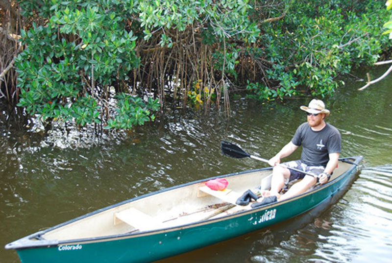 Derek Smith prepares to head out for an ecological survey by canoe. With the site being uninhabited, many areas were only accessible via canoe or by cutting paths through the jungle with machetes.