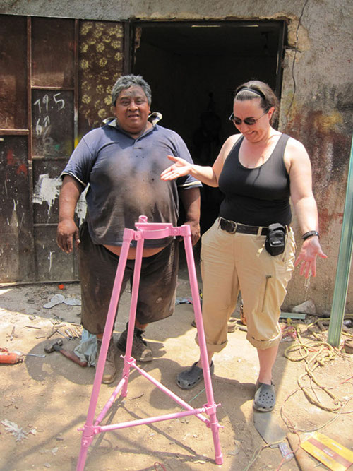 Trish Beddows proudly stands with Freddy Flores, Kantunilkin’s local welder who created coring equipment, including this pink tripod for the project.