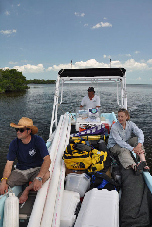 Surrounded by equipment and supplies for several days of field work, Dominique Rissolo and Beverly Goodman arrive at Vista Alegre on one of the local <em>lanchas</em> from Chiquila, captained by Roberto Echevaria.