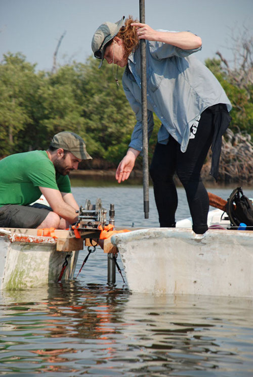 Working on the project’s mobile coring platform, Wes Patterson and Beverly Goodman test out the Livingston Corer in the East Harbor.