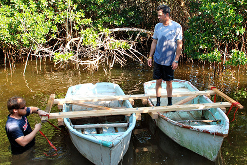 Derek Smith and Dominique Rissolo put the final touches on the coring platform, constructed using 2 x 4s and two derelict dingys found in Chinquila.