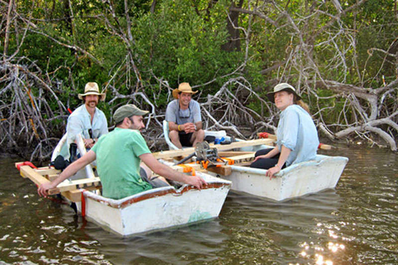 Pulling the mobile coring platform out of the sun, Jeffrey Glover, Wes Patterson, Dominique Rissolo and Beverly Goodman sit and discuss options for collecting cores in the East Harbor. Many discussions and sharing of new ideas in the field assisted in the overall success of the expedition.