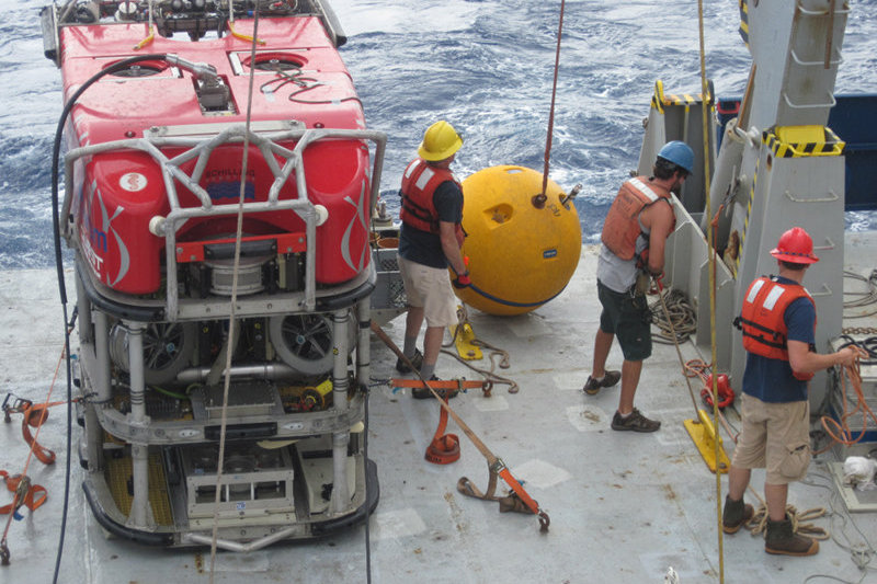 Lowering the buoy attached to the mooring as the hydrophone and other instrumentation near W. Mata is recovered.