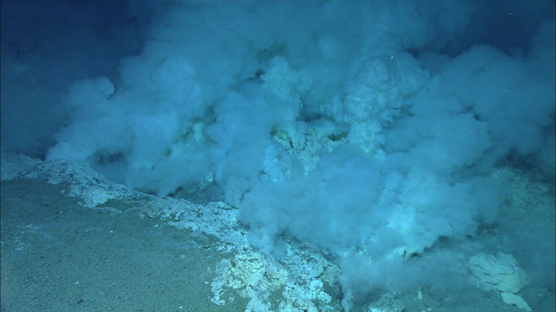 Jets of sulfur shooting out from holes in the sediment-covered seafloor at Niua North.
