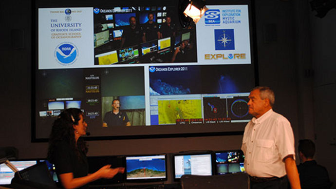 Dennis Nixon, University of Rhode Island (URI) Graduate School of Oceanography Associate Dean and Catalina Martinez, NOAA Office of Ocean Exploration and Research RI Regional Manager, hosting a media event in the URI Inner Space Center during the 2011 field season while interacting live with both the NOAA ship Okeanos Explorer working in the Caribbean Sea (top and bottom right screens in background) and the Ocean Exploration Trust Exploration Vessel (E/V) Nautilus working in the Black Sea (bottom left screen).