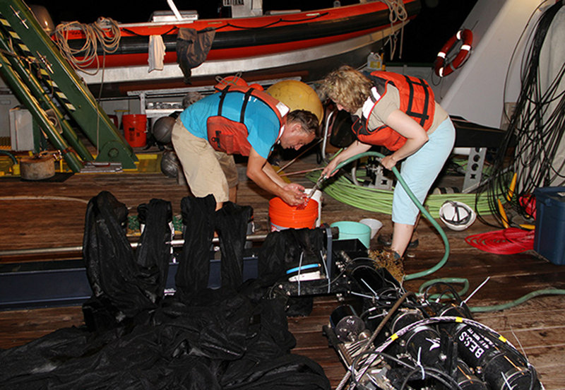 Rinsing one of the MOCNESS nets with seawater.