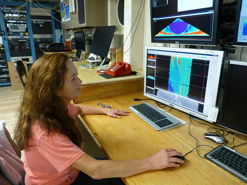 Susan Merle monitors the data collected by the ship’s Multibeam Sonar.