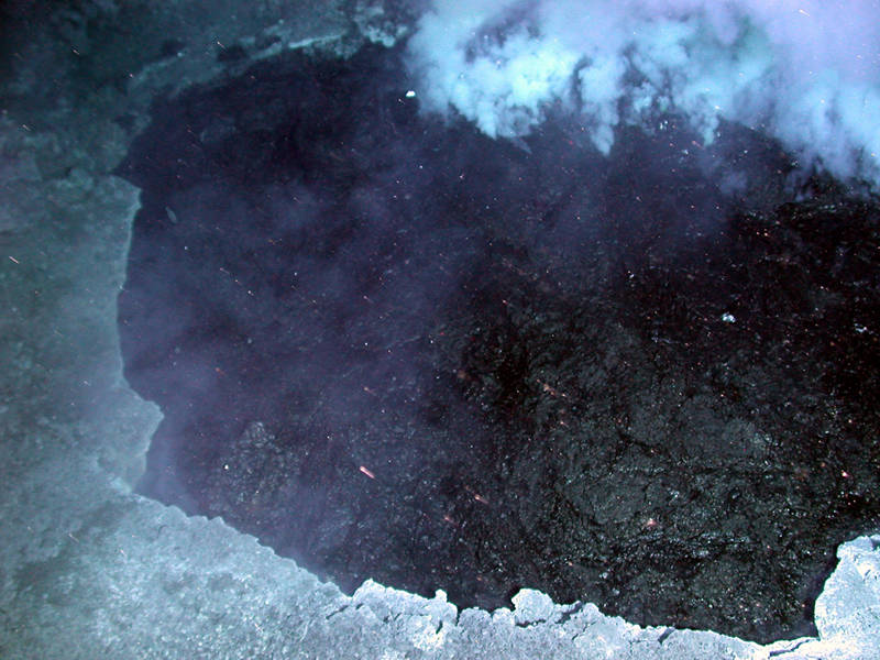 This pond of molten sulfur (approximately five meters across and black due to its high-iron content) was discovered roiling in the bottom of a small crater (from the 2006 Submarine Ring of Fire expedition).