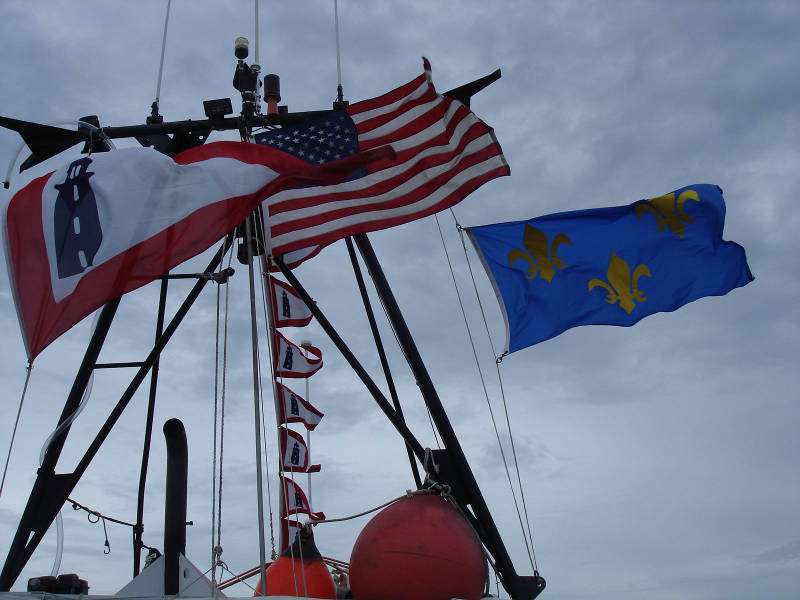 Flying the colors on the way home! The large pennant on the left, and the smaller versions in the middle, are the old flag of the U.S. Lighthouse Service, the former government agency that regulated Lighthouses. At the right is the French flag that formerly flew over Fort Caroline National Memorial.