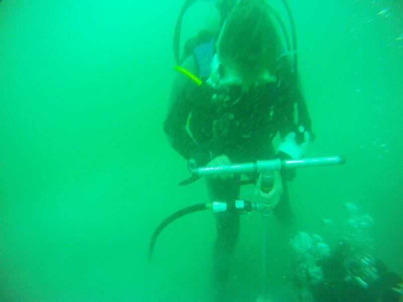 Olivia forces the probe down into the sediments, with only a few feet to go. At the bottom Shelly assists her, helping push the probe further down.