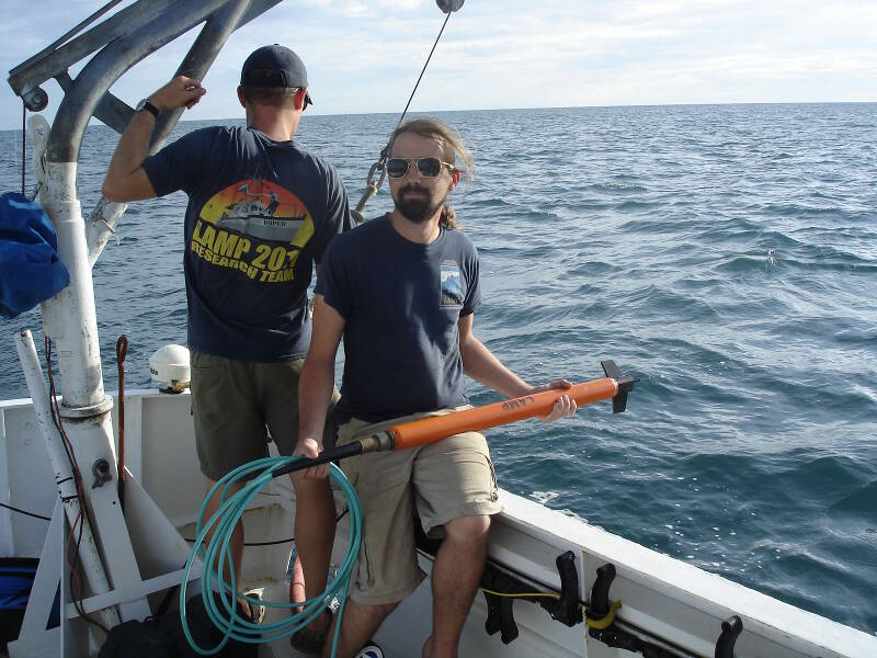 Brian McNamara, LAMP volunteer archaeologist and Flinders University graduate student, standing by with the magnetometer “fish,” waiting to launch it into the sea.