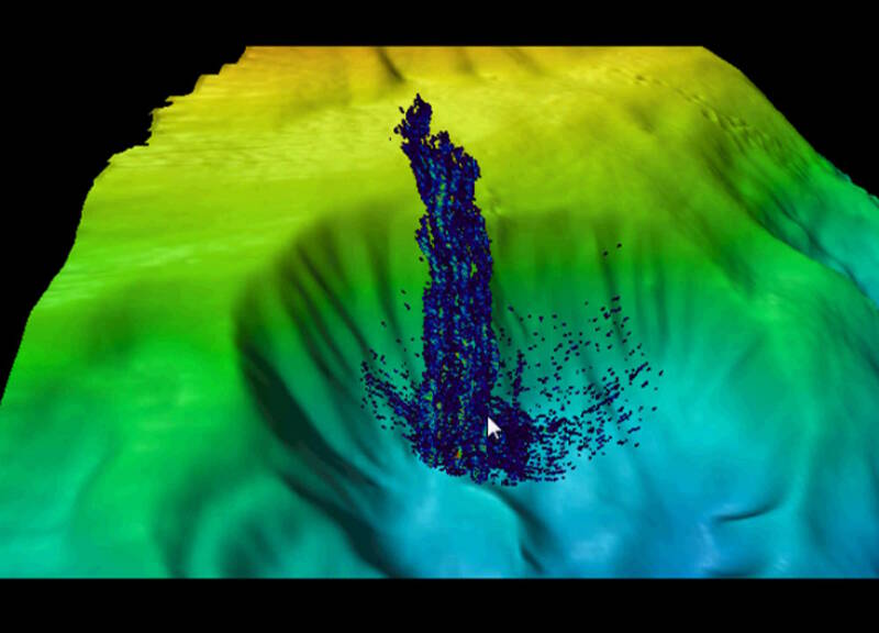 Gas plume rising from the base of a large, amphitheater-like feature.