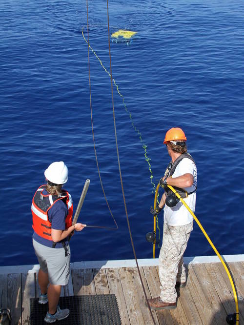 Jason White and LT Heather Moe recover the Mohawk 18 ROV to the deck of the Walton Smith