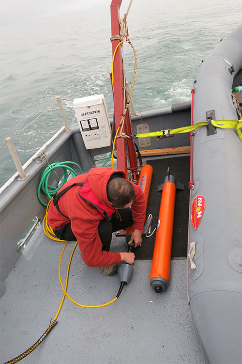 Matthew Lawrence prepares one of the magnetometers for deployment.