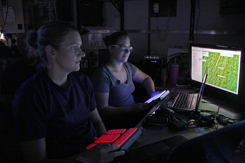 Lt. Heather Moe, of the National Marine Fisheries Service’s Southeast Fisheries Science Center, (foreground) identifies fish species on a monitor during remotely operated vehicle dives