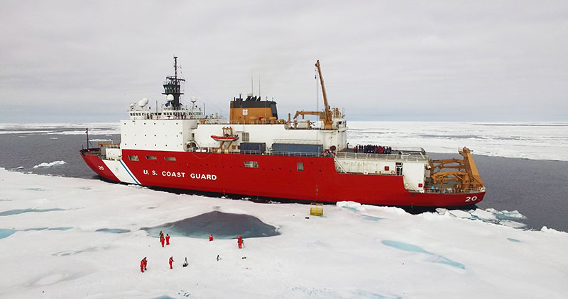 The U.S. Coast Guard Cutter Healy sits alongside an ice floe to allow science operations to occur. 
