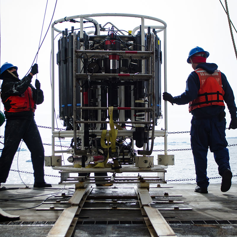 Members of the U.S. Coast Guard prepare the CTD for launch.