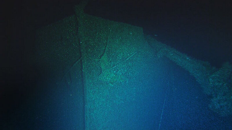 A video frame grab of the bow of the SS Bluefields. The collapsed forward deck crane hangs off the bow of the Bluefields. An anchor can be seen hanging in place in the hawse pipe. Image courtesy of John McCord, UNC Coastal Studies Institute - Battle of the Atlantic expedition.