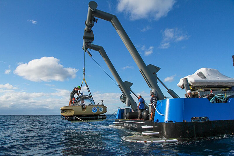 Project Baseline's Nomad submerible is hoisted aboard R/V Baseline Explorer after resurfacing from a dive. Image courtesy of David Sybert, UNC Coastal Studies Institute - Battle of the Atlantic expedition.