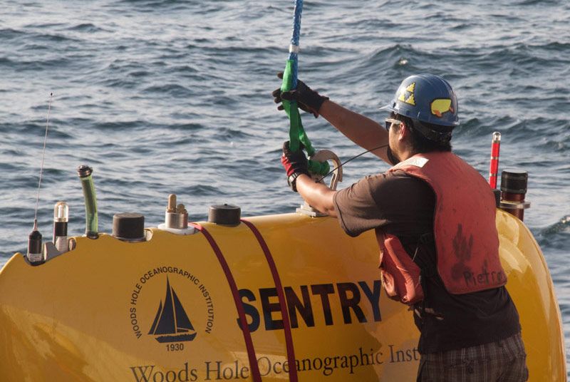 Justin Fujii, mechanical engineer at Woods Hole Oceanographic Institution prepares Sentry for the practice launch.