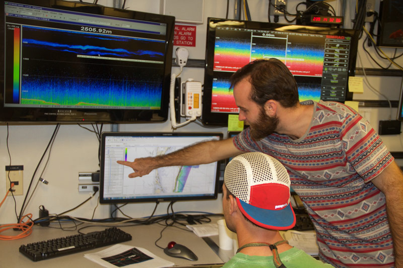 Shelby, aboard NOAA Ship Pisces, using existing multibeam data to create a map for the Exploring Carolina Canyons expedition.