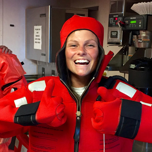 Molly dons a survival suit on NOAA Ship Pisces.