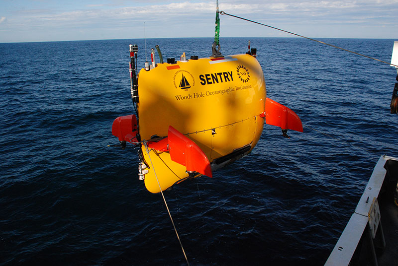 The ship’s crane operator slowly moves the Sentry over the side and back onto the deck.