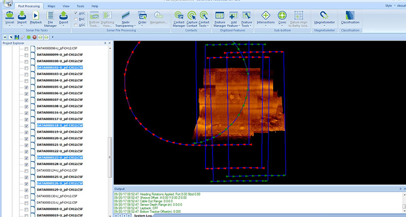 Screen capture of an intermediate stage of building the side-scan mosaic. The blue lines and arrows show the bounds and port (red arrow) and starboard (green arrow) sides of the individual imagery files collected by Sentry. At this stage, the outside edges of the individual images have been trimmed to remove parts of these data outside the visible range and the intensities of the acoustic returns have been compared and normalized.