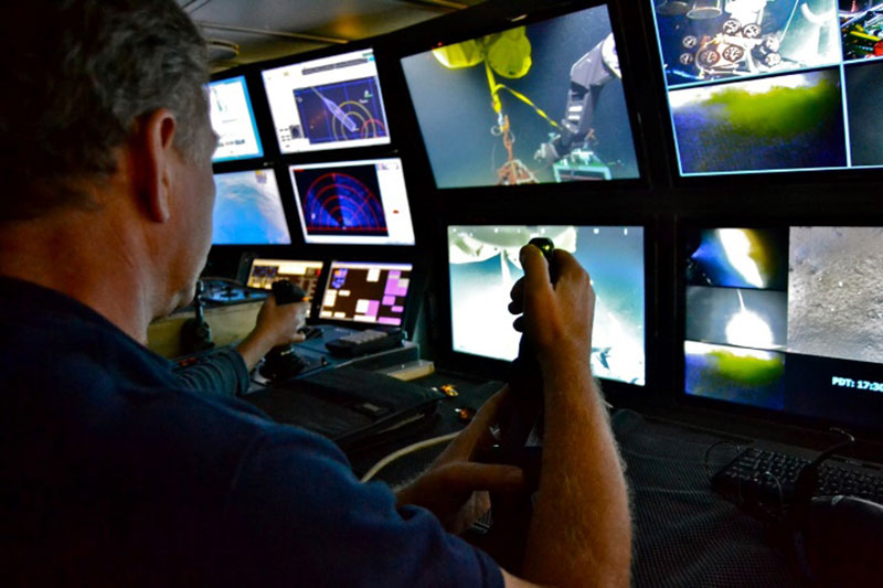 A ROPOS pilot operating the manipulators from the surface vessel.