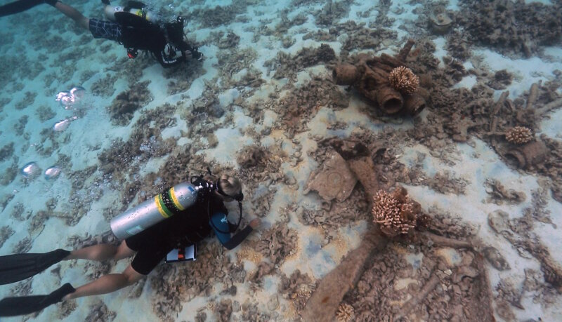 Maritime archaeologists document the remains of a Brewster F2A-3 Buffalo at Midway Atoll.