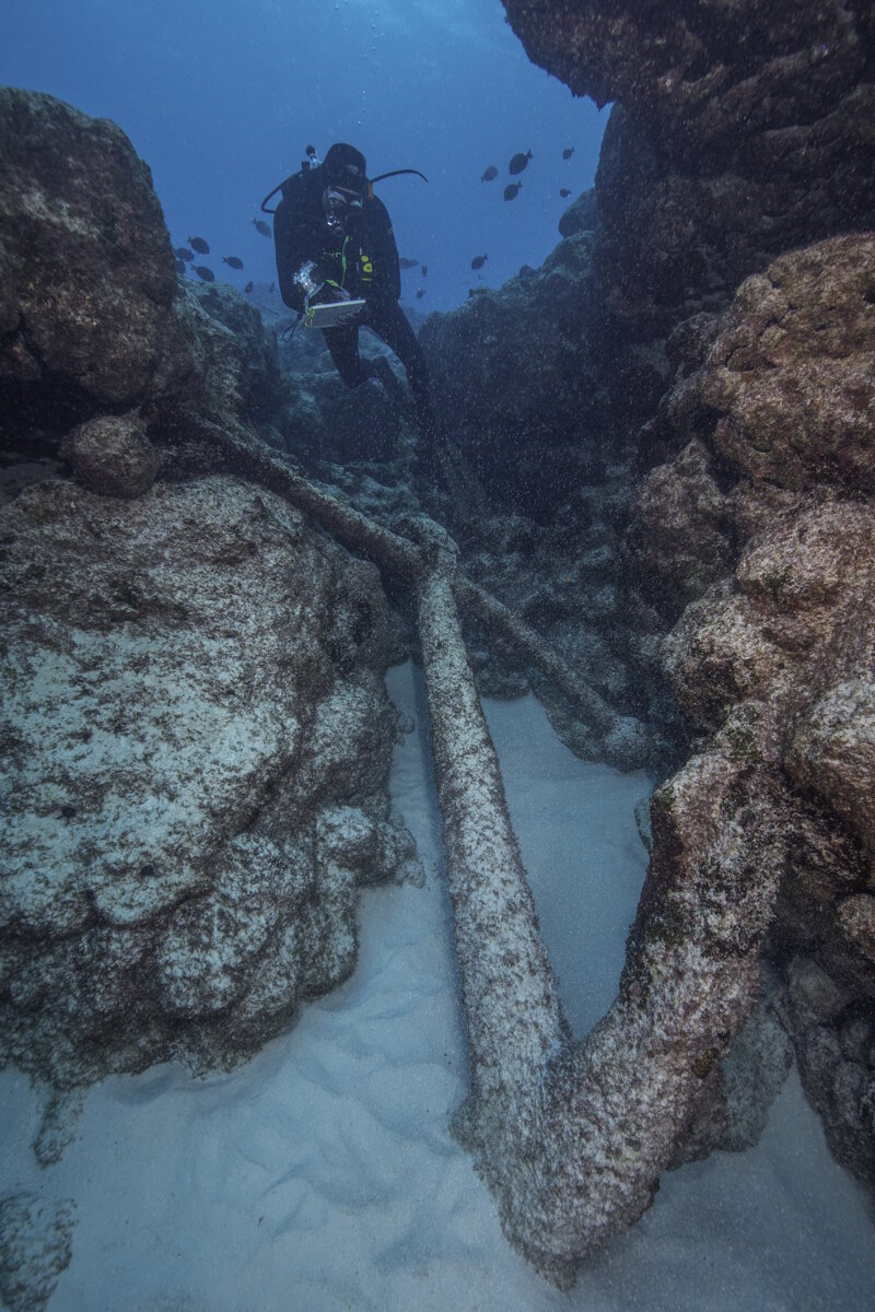 Brian Hauk takes notes on a recently discovered potential whaling anchor.