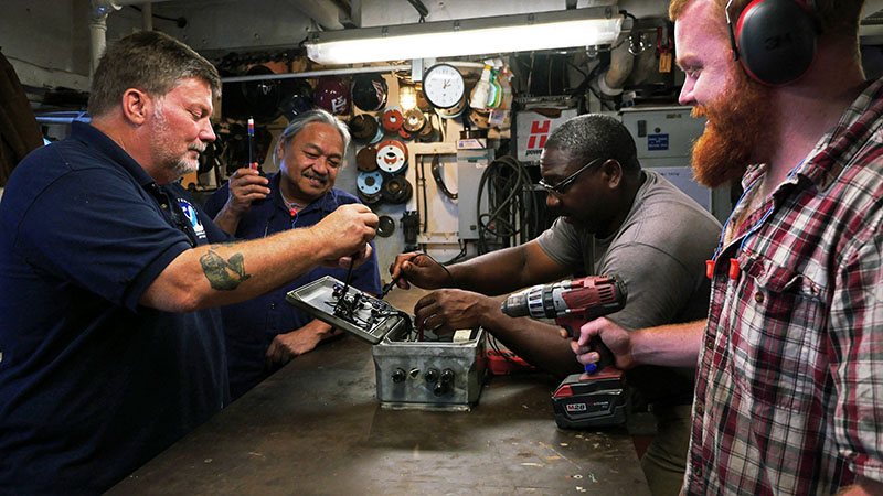 Left to right: CME Tim Olsen, 1AE Carlito Delapina, JUE Joe Clark, and 2AE Kyle Williams in the ship’s machine shop.