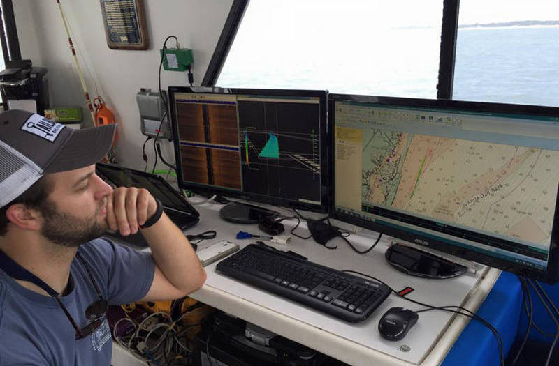 A survey technician observes the acoustic survey data and navigation information in real time as a marine survey progresses.