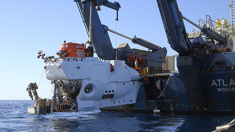 Launching Alvin into the sea; note the sampling basket at the forward part of the sub with all of the sampling equipment attached.