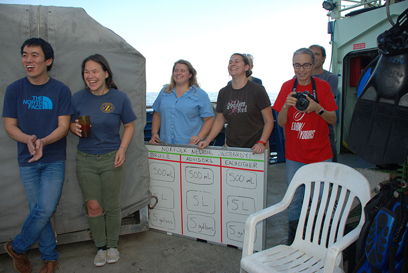 Team DEEP SEARCH looks on as Ryan and Lauren carefully make their selections from an ice-bath-themed trivia board.