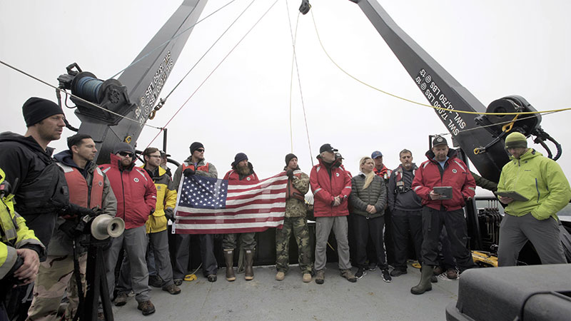 The project team and members of the crew of the R/V Norseman II conduct a wreath ceremony to honor the final resting place of the 71 sailors lost on the USS Abner Read.